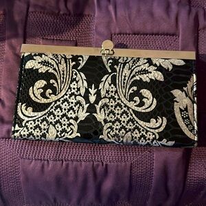 Clutch black and silver 7 1/2 inches wide 4 inches high quarter inch with